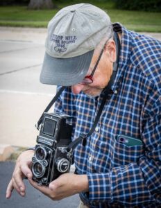 Thomas Nelshoppen tries out a Rollieflex camera made in the 1950s