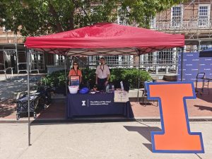 Tech points table outside of the Illini union with volunteers