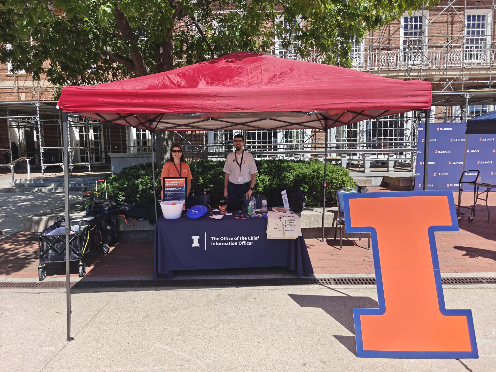 Tech points table outside of the Illini union with volunteers