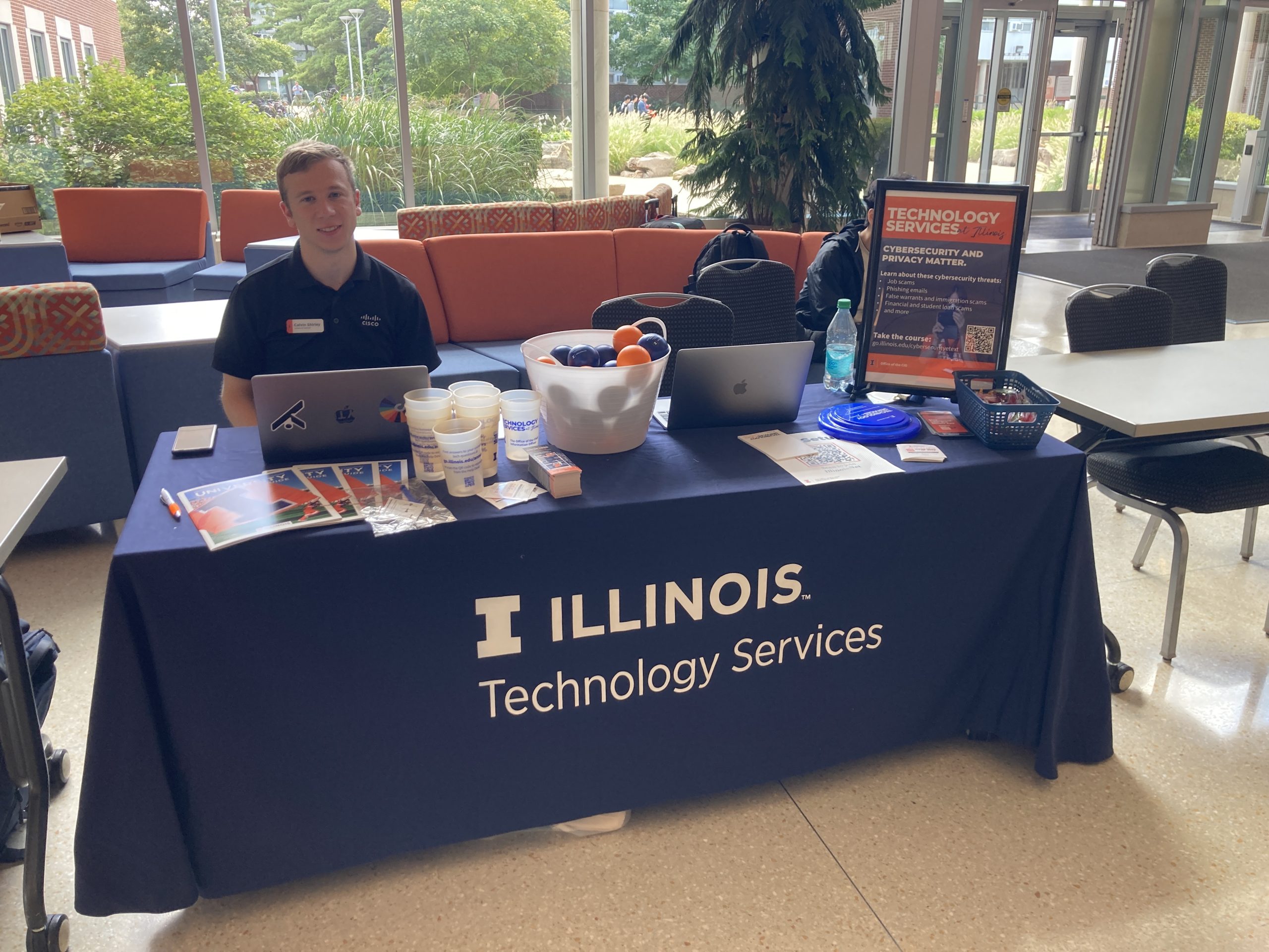 Tech Points table with one volunter located inside of Ikenberry Commons.