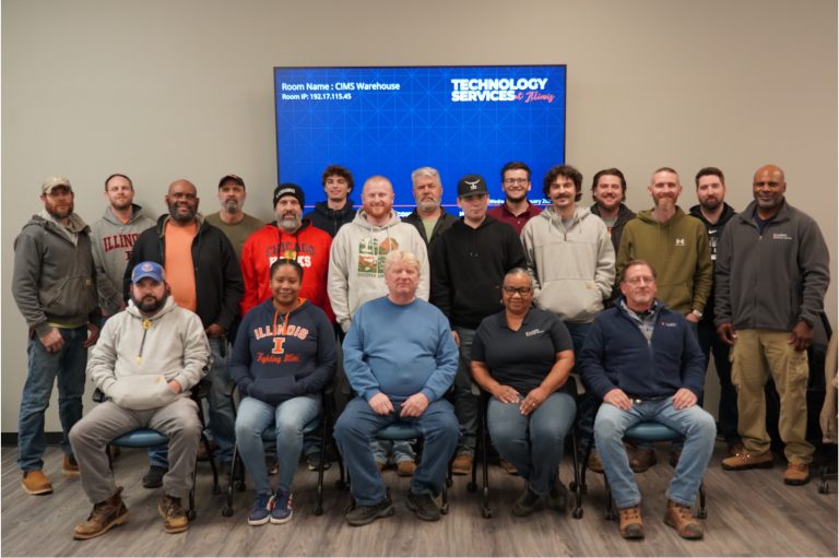 Group photo of the CIMS team smiling in the new space